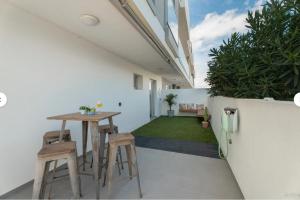 a small patio with a table and stools in a house at Tejita Beach in La Tejita