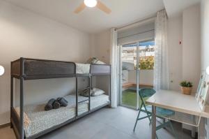 a bedroom with a bunk bed and a desk at Tejita Beach in La Tejita