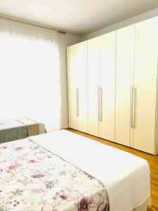a bedroom with a bed and white cabinets at Appartamento Crema centro in Crema