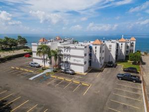an aerial view of a parking lot in front of a building at Isla | The Sunset Abode in Ocean Club, Rincón in Corcega