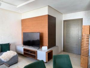 a living room with a flat screen tv on a wall at Agadir bay luxury in Agadir