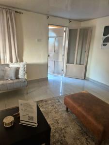 a living room with a couch and a table at Palm and Pillow in Freetown