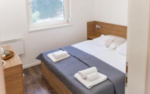 Postel nebo postele na pokoji v ubytování Pogánykő Vendégház 2