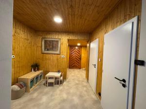 a hallway of a house with a wooden wall at Chaloupka Příchovice in Kořenov