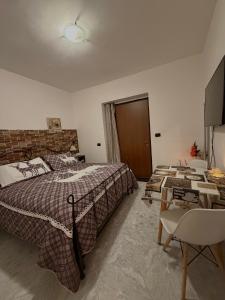 a bedroom with a large bed and a chair at Camera dell' antico Arco Romano in Pozzuoli