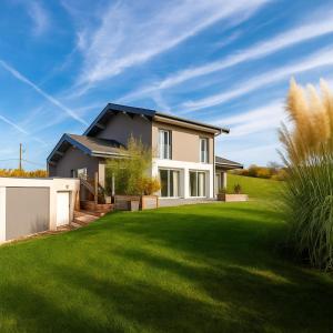 a house with a green lawn at Villa d'architecte in Marin
