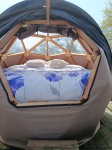 a bed in a gazebo with a canopy at Dôme étoilé in Pléneuf-Val-André