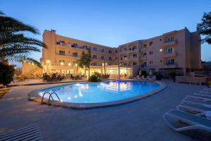 a large swimming pool in front of a building at Hotel LLITERAS in Cala Ratjada