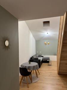 a living room with a table and a couch at L escapade pro in La Roche-Chalais