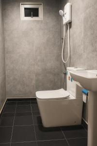 a bathroom with a toilet and a sink at Noa Sands By Ceylon Vistas in Talpe +18 photos