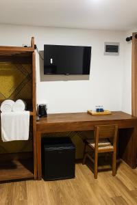 a room with a desk and a tv on a wall at Noa Sands By Ceylon Vistas in Talpe