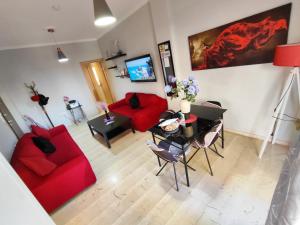 a living room with a red couch and a table at Marlen House Chania in Chania