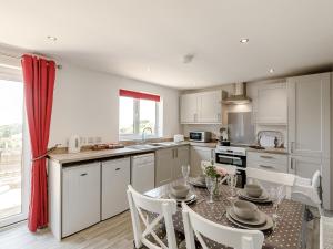 a kitchen with a table with chairs and a dining room at Hill Crest Lodge 1 in Hemswell +18 photos