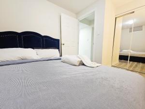 a bedroom with a large bed with a large mirror at Garden Ave Suite 3 Mins to Hwy 403 in Brantford