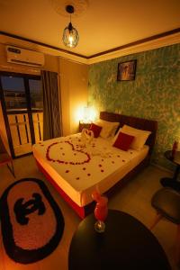 a bedroom with a bed with a dog on it at Résidence JTC in Douala