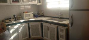 a kitchen with a sink and a microwave at WaterMill House in Wadi Musa