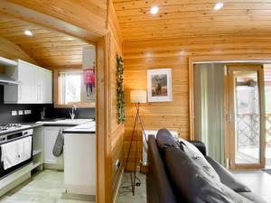 a kitchen with wooden walls and a wooden ceiling at Apple-Uk46285 in Camerton