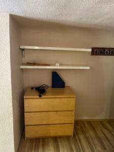 a bedroom with a wooden dresser and shelves at Chambre avec salle de bain privative centre d'Aix in Aix-en-Provence +26 photos