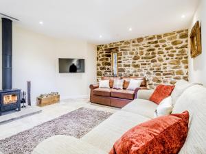 a living room with two couches and a fireplace at Owl Barn -- Uk30757 in Bream