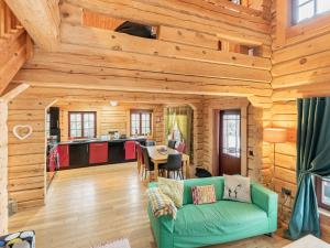 a living room with a green couch in a log cabin at Ty Ceirios - Uk42100 in Carno