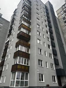 a tall grey building with many windows at 2 kambarių butas Alytuje in Alytus