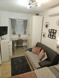 a living room with a couch and a desk at Apartment Maja - Strict center of Zagreb in Zagreb