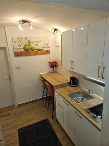 a small kitchen with a sink and a counter at Apartment Maja - Strict center of Zagreb in Zagreb