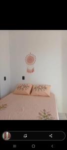 a bedroom with a bed with pink sheets at Brisa Oceanica in Itarema