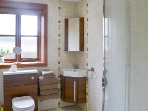 a bathroom with a toilet and a sink and a shower at George's Gaff - E4432 in Ingoldmells +5 photos