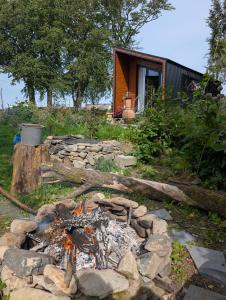 a stone fire pit in front of a house at Hilltop Cabin in Cultra +5 photos