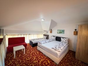 a bedroom with a bed and a couch and a chair at Residence Mahala - Boutique Stay Near Old Town in Sarajevo