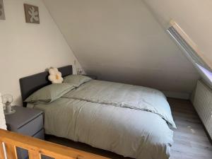 a bedroom with a bed with a teddy bear on it at Villa Dune I in Ouddorp +35 photos