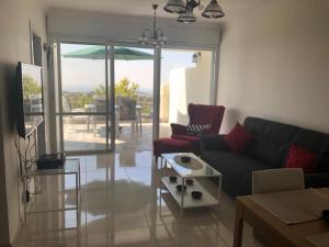 a living room with a couch and a table at Exotic Vacation in the Jerusalem Mountains in Shoresh
