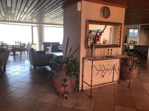 a room with plants and a mirror on a wall at Exotic Vacation in the Jerusalem Mountains in Shoresh