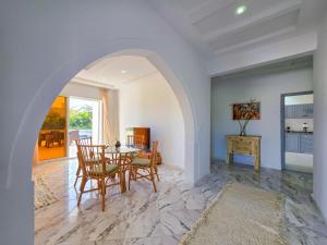 a dining room with a table and chairs at Tezdaine's garden in Bin Rhilouf