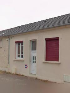 a white building with two windows and a door at Le Dagonneau in Varennes Vauzelles