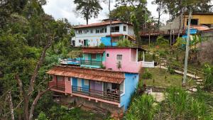 a group of houses on the side of a hill at Pousada Flor da Mata in Nova Lima