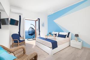a bedroom with a bed and a chair and a table at Mare Sunset & Relax in Meta