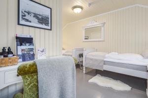 a room with two beds and a table and a chair at STØTT top of Helgeland in Støtt