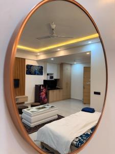 a mirror reflecting a room with a bed and a kitchen at Your own bnb in Ghaziabad