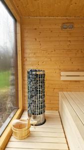 a sauna with a heater in a wooden room at Rekreačné zariadenie Čingov - Slovenský raj in Spišské Tomášovce