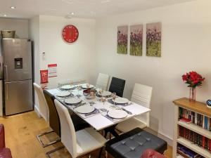 a dining room table with chairs and a refrigerator at Cobble Cottage - Uk38973 in Whitby