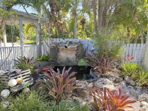 a garden with a fountain in a yard at Caribbean Sunsets in Marathon