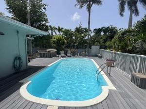 a large swimming pool on a wooden deck at Caribbean Sunsets in Marathon