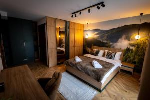 フンドゥ・モルドベイにあるChalet Sonnenhangの壁に絵が飾られたベッドのある寝室