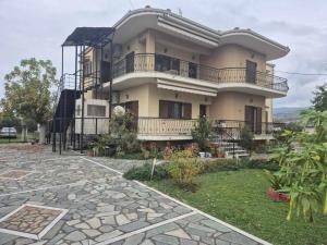 a large house with a balcony on top of it at Casa del Campo Trikala in Chrysavgí
