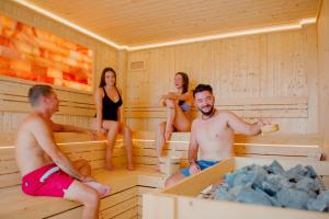 a group of people sitting in a sauna at Tolani Resort Koh Samui in Lamai