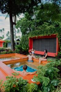 a group of people sitting in a swimming pool at Tolani Resort Koh Samui in Lamai