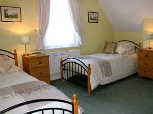 een slaapkamer met twee bedden en een raam bij Blencathra House in Keswick +14 foto's