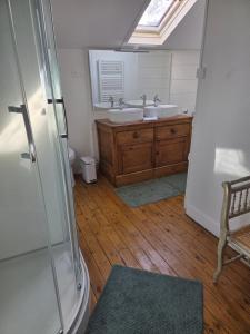 a bathroom with two sinks and a mirror at Le Polygone in Le Mans